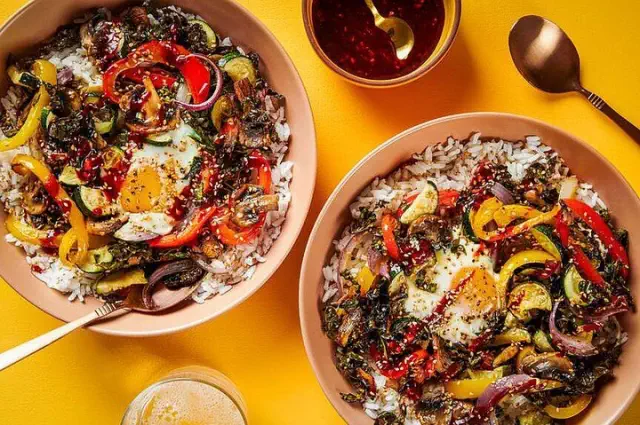 This roasted vegetable bibimbap offers a harmonious blend of flavors in every mouthful.