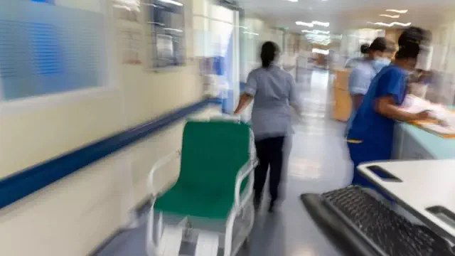 NHS hospitals overwhelmed by flu cases are hiring 'corridor nurses' to provide care for patients in crowded hallways.